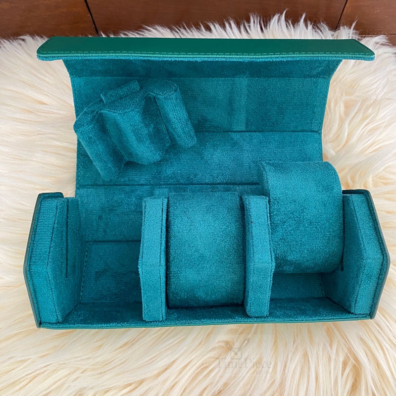 Opened 3-watch green hexagon shaped watch case, showing the green velvet inside with M-shaped watch cushions that can be easily slide out.