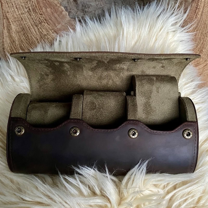 Coffee colour cowhide leather watch case that is opened, showing velvety inside and watch cushions that can slide out individually.